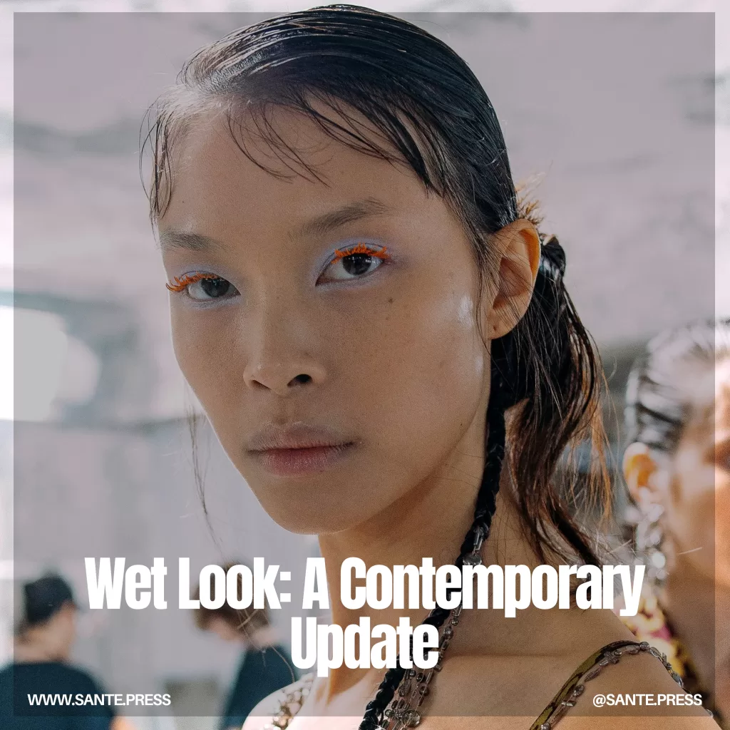 A modern side bun with a wetlook finish, showcasing a sleek and shiny style suitable for elegant events.