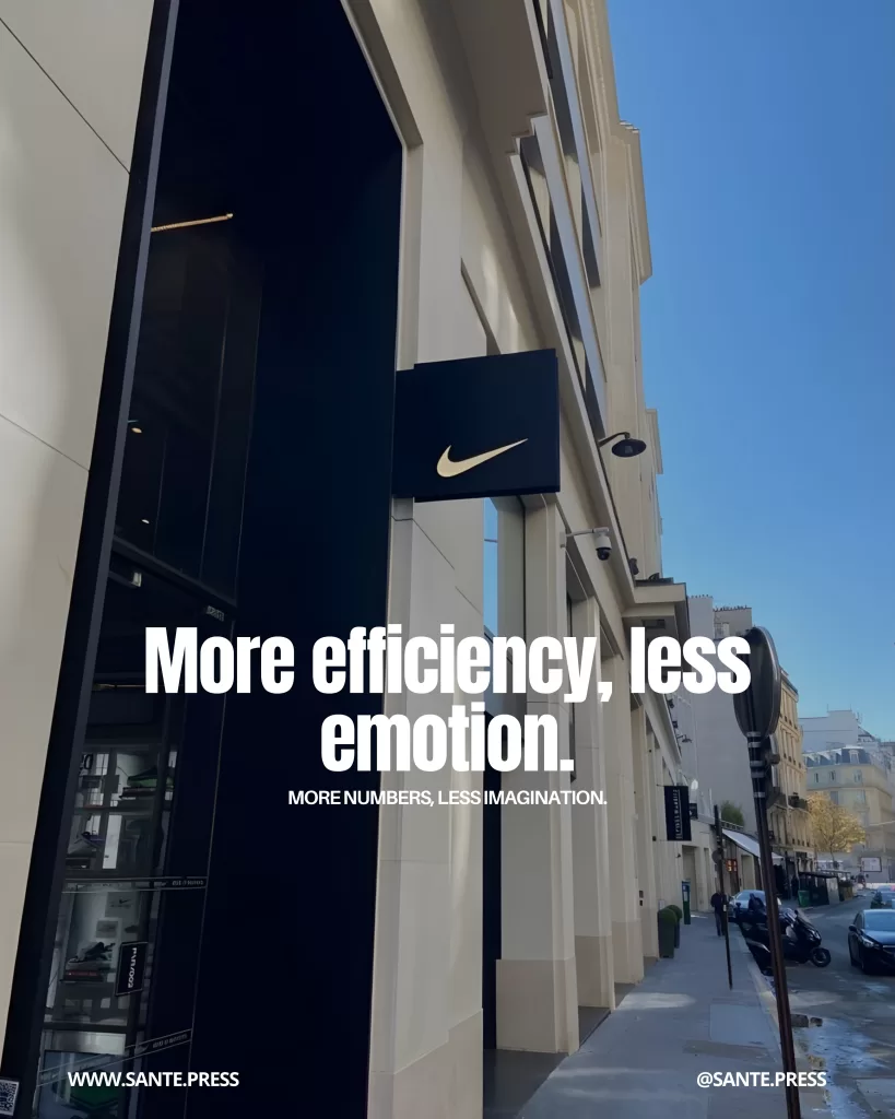 Facade of a Nike store on an elegant urban street with the logo visible on the sign. Text: “More efficiency, less emotion. More data, less imagination.”
