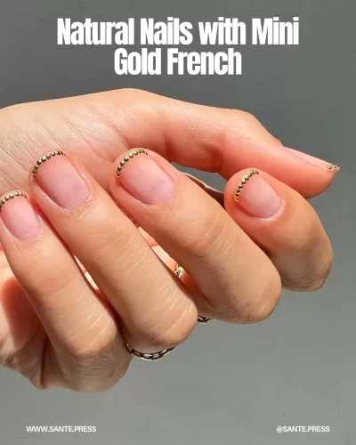 Natural nails featuring a mini gold French tip design, offering an elegant and subtle touch for special occasions.